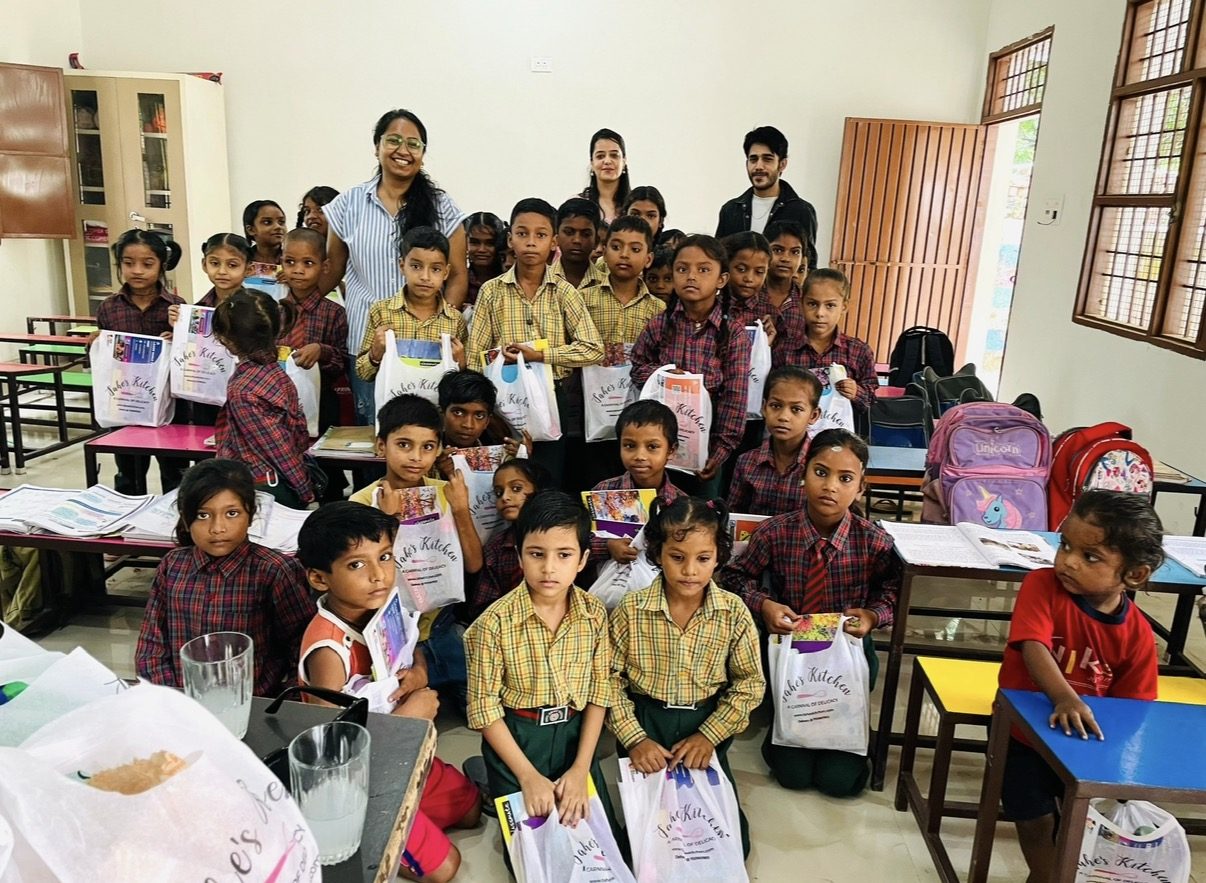 CP, Taniya, and Nav distributing gift bags to school children