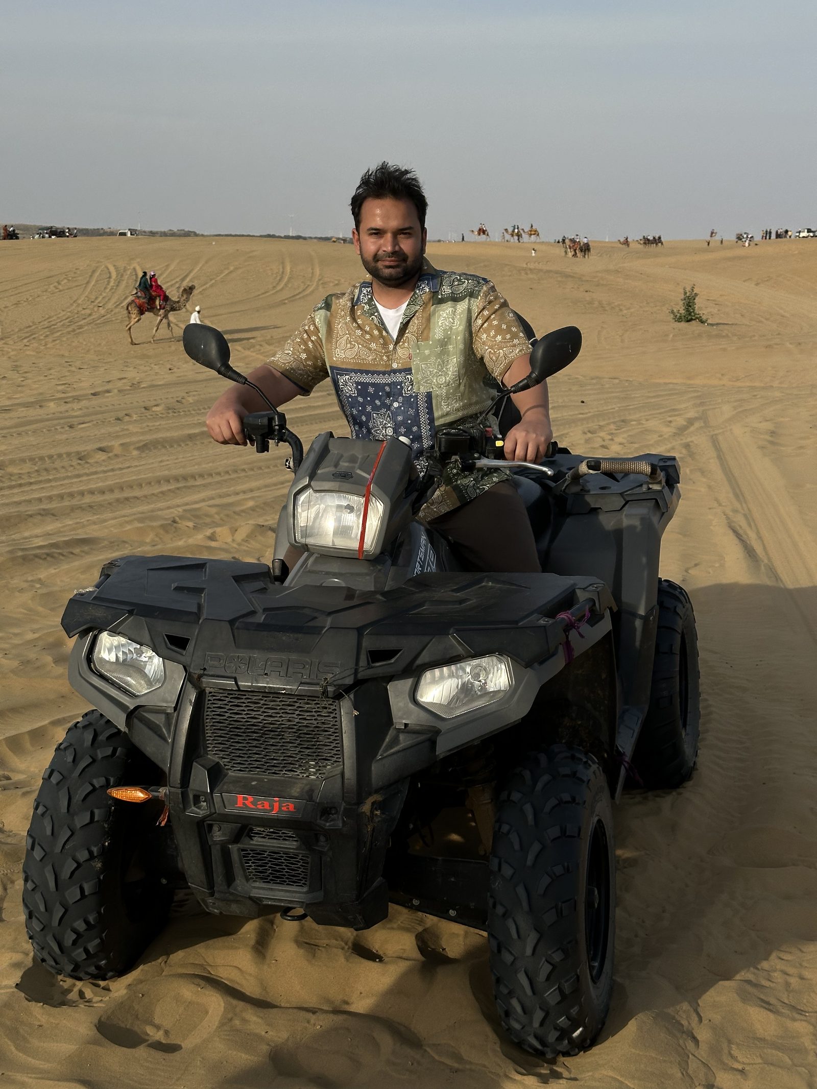 Manu on an ATV in the desert